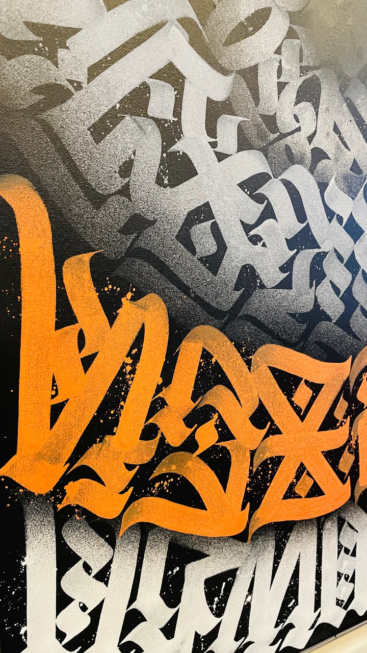 Bottom left angled view of the amber artwork, highlighting the depth and texture of the calligraphic brushstrokes.