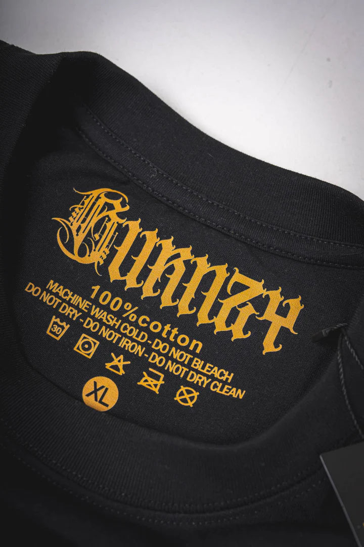 Close-up of the logo tag on the Burnzy Art T-shirt, featuring branding and fine detail of the label.