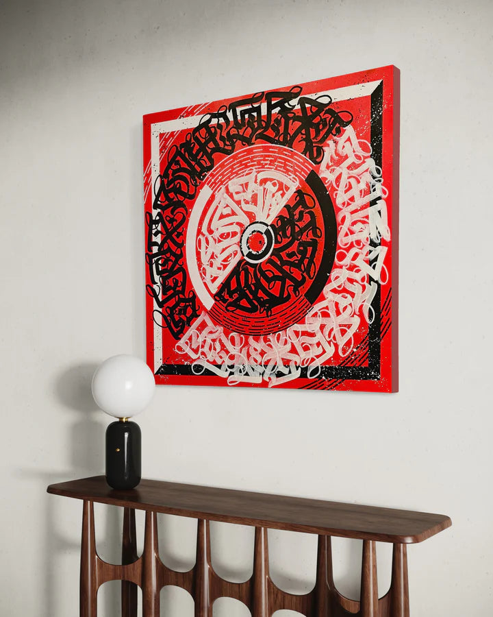 CIRCLES OF EXPRESSION RED mounted on a wall – showcasing its bold circular composition and calligraphic energy in a room setting.