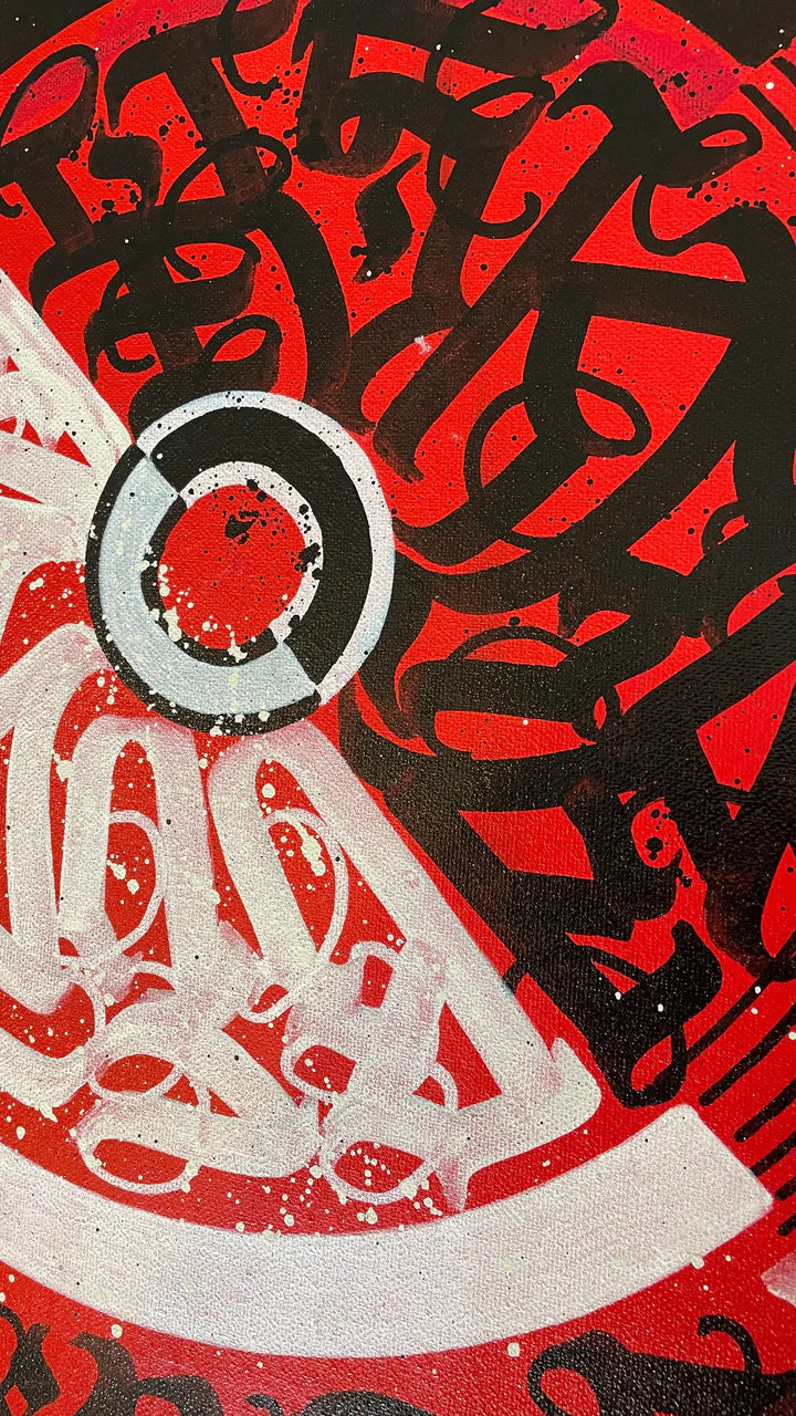 Close-up view of the center design in CIRCLES OF EXPRESSION RED – showing intricate layers of calligraphy in vibrant red and black.