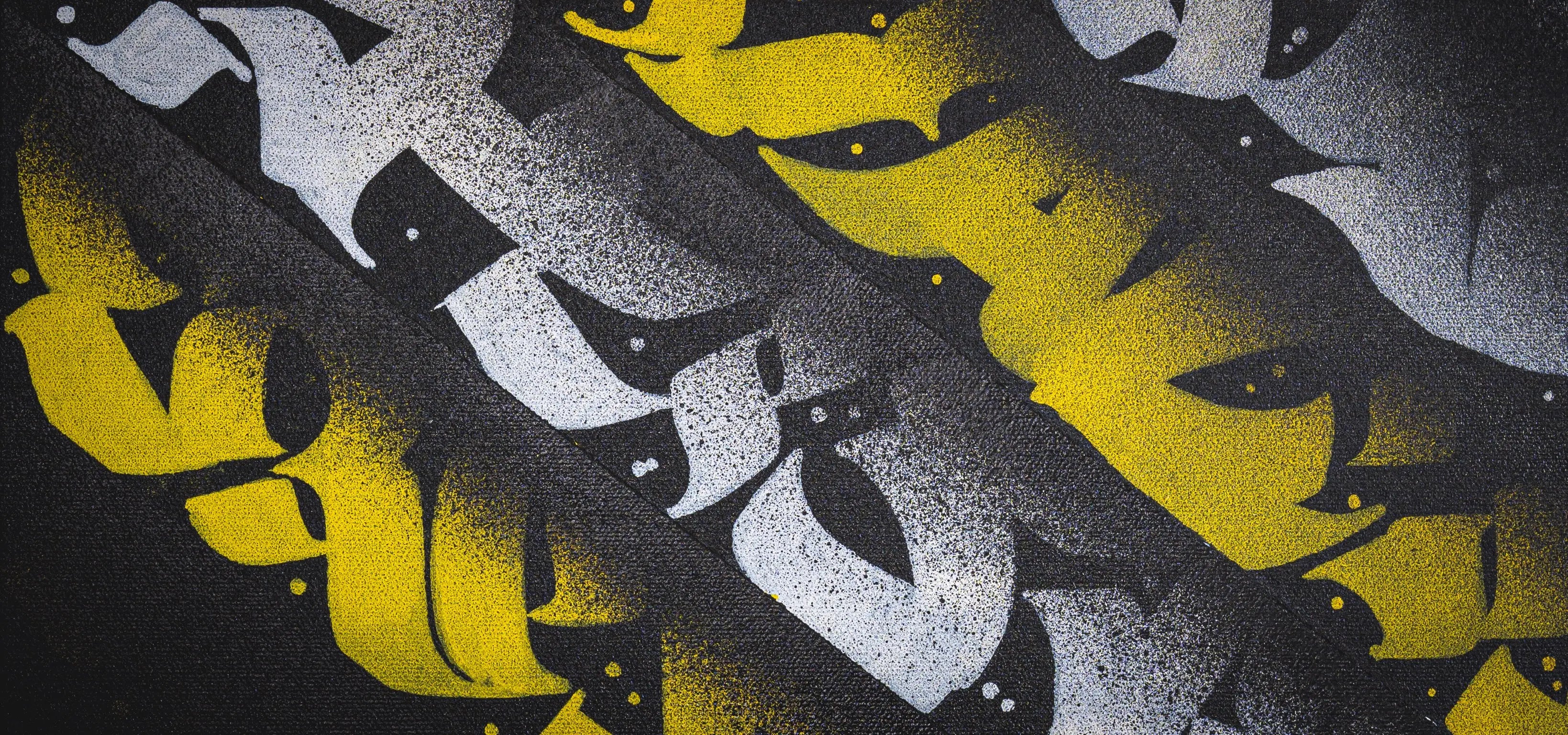 Angled close-up of THE KILLER BEE – showing abstract forms and stylized calligraphy strokes within the geometric layout.