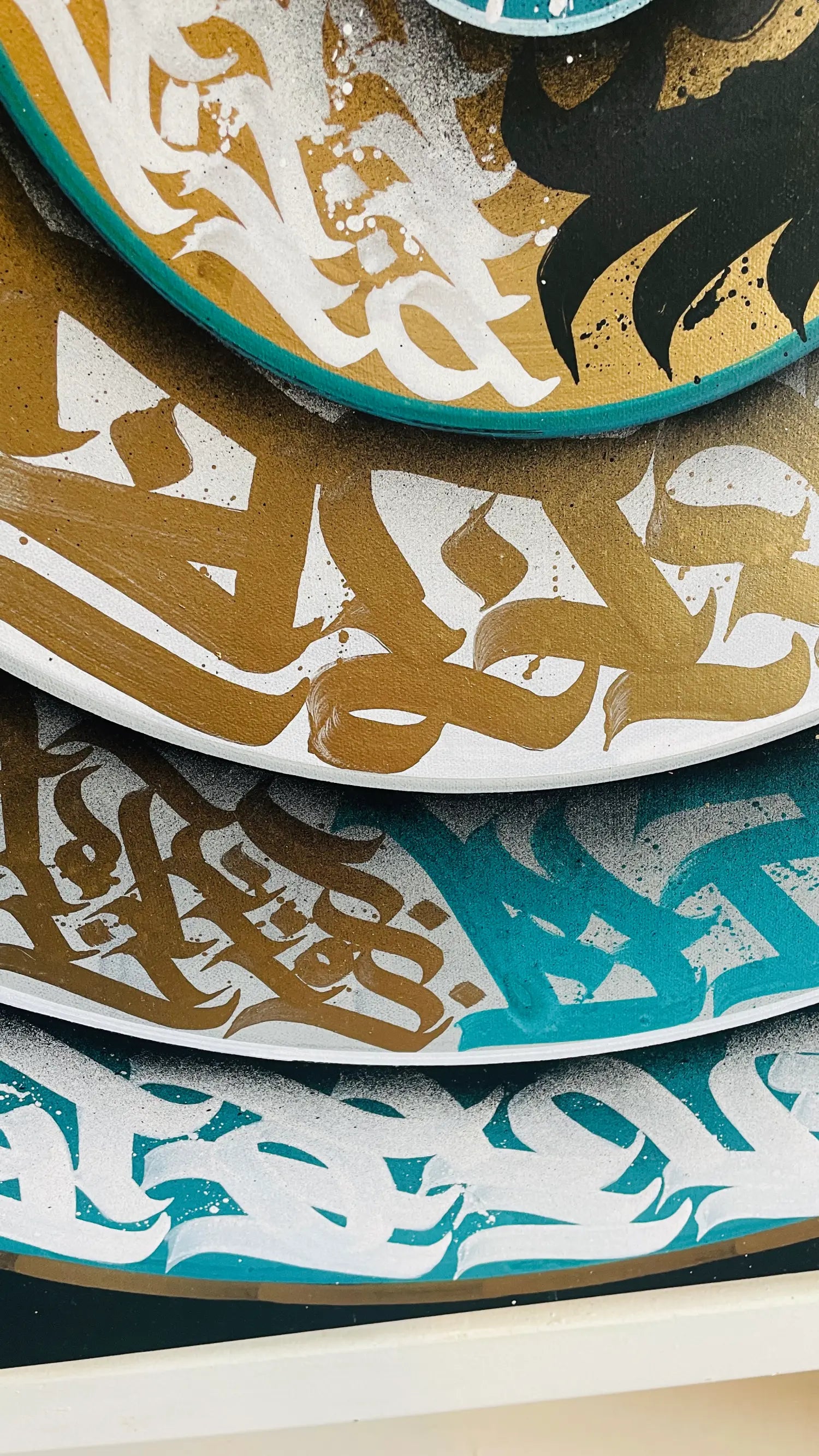 Bottom side angle of THE TURQUOISE TORNADO – showing paint texture, flowing calligraphic forms, and turquoise-gold contrast on this swirling acrylic masterpiece.
