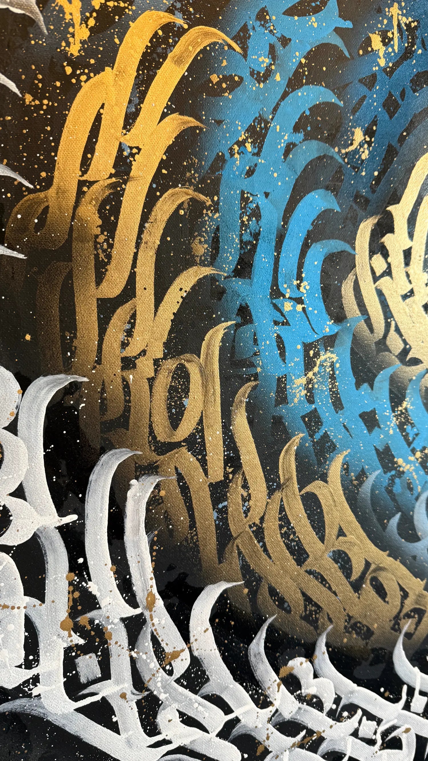 Burnzy art sub zero Close-up of ornate text in gold, blue, and white on a textured background