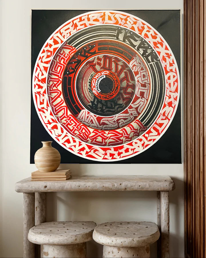 The Calli Disk calligraffiti canvas mounted on a wall, showing its striking visual impact and modern aesthetic in a room setting.