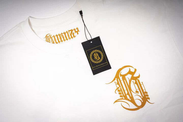 Close-up top view of the white Burnzy calligraphy t-shirt, showcasing the texture and fabric detail near the collar.