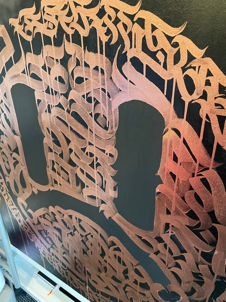 Detail shot of graphic calligraphy and layered spray paint