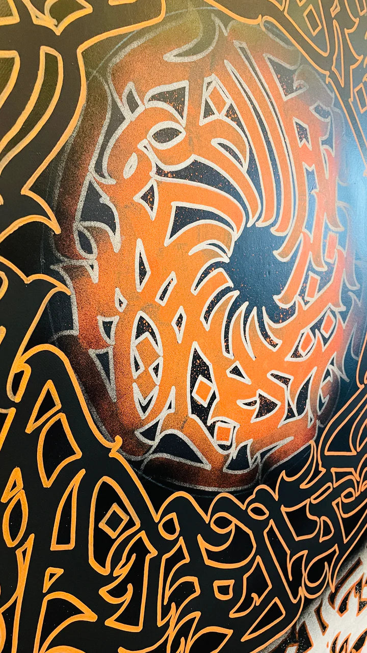 Bottom left angle close-up of “VOLCANIC VERSES,” revealing intricate calligraphy and texture that evoke the movement of molten flames.